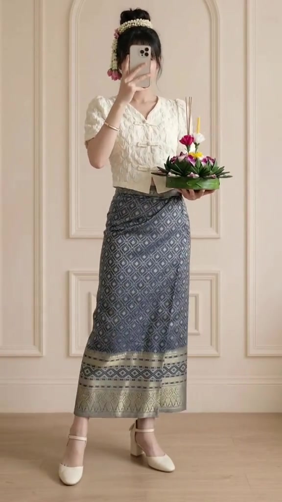 ตัวอย่างลุคเสื้อคอจีนสีครีมจับคู่ผ้าถุงลายไทยสีเทาอมฟ้า ชายผ้าถุงยาวระดับข้อเท้าใส่กับรองเท้าส้นสูงสีครีม