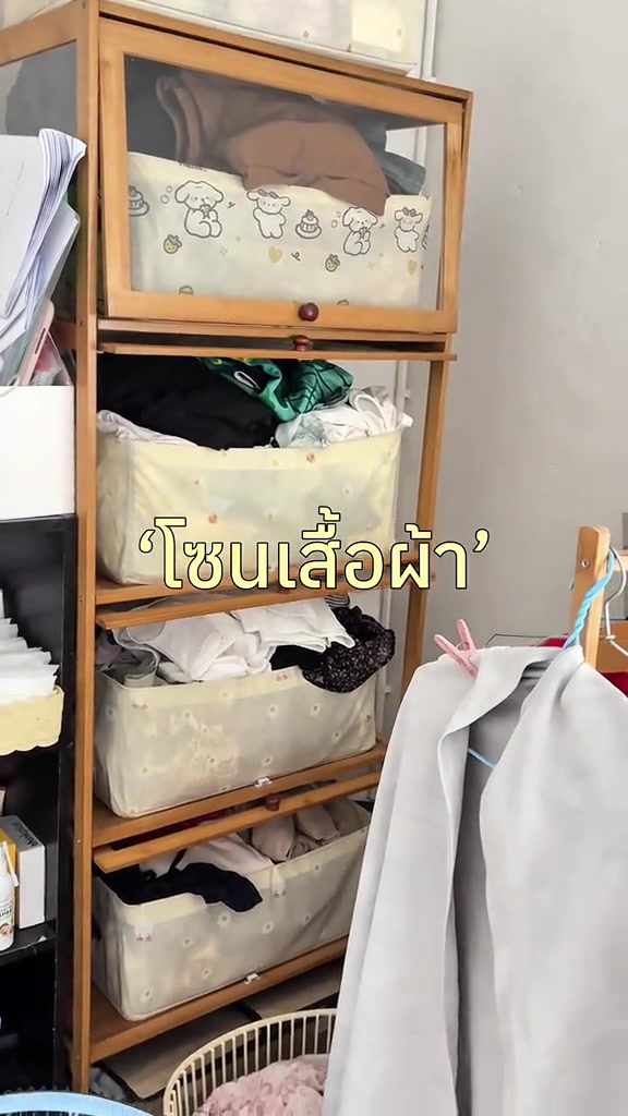 ตู้เก็บเสื้อผ้าในห้องเล็กที่มีเสื้อผ้าและกล่องเก็บของหลายชั้น